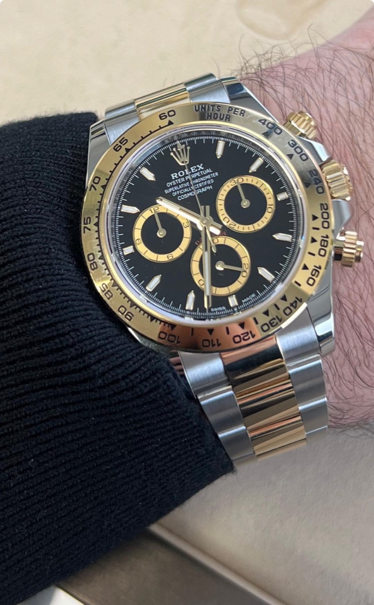 Rolex Cosmograph Daytona, two-tone with a black dial, worn on the wrist