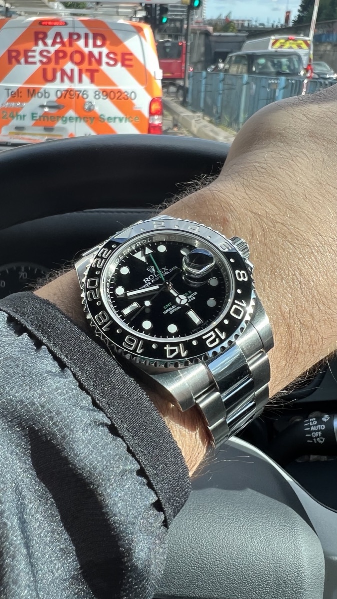 Rolex GMT-Master II with a black bezel, worn on the wrist